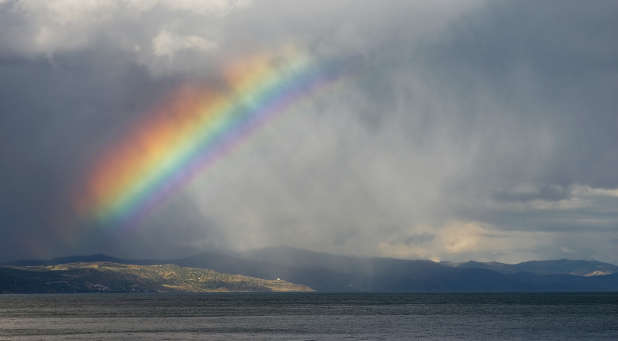 A rainbow breaks through the storm clouds